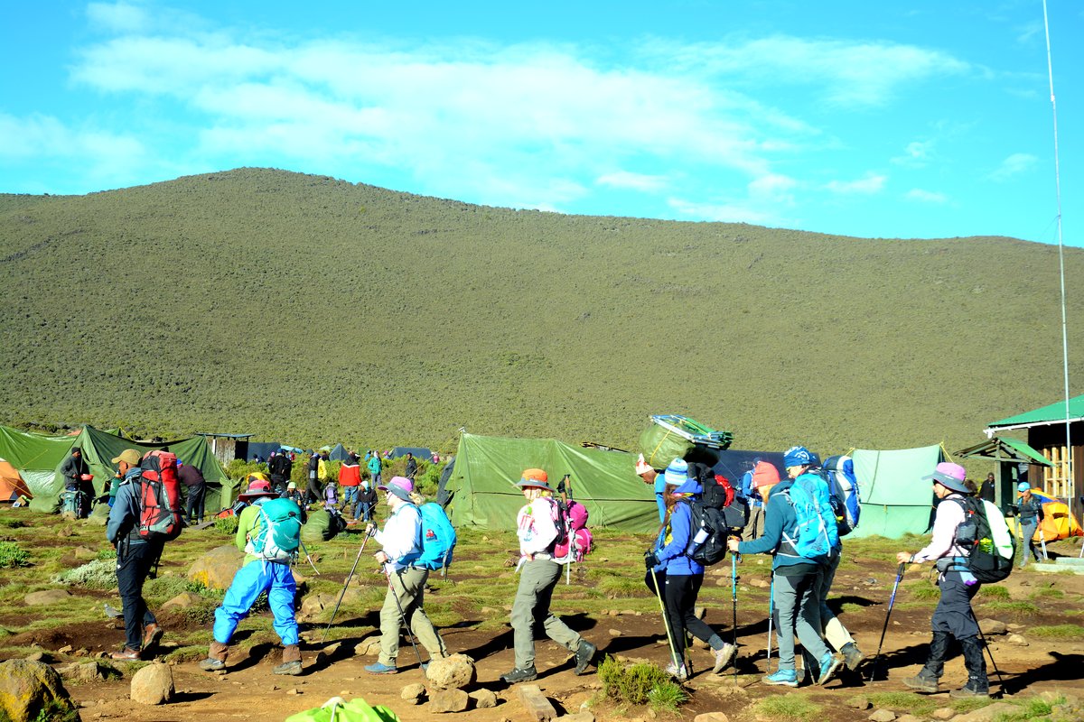 Tents spread across open moorland at camp